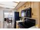 Well-equipped kitchen with modern black appliances, wooden cabinets, and a view into the adjacent dining area at 3320 Gulf Of Mexico Dr # 307C, Longboat Key, FL 34228