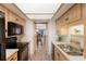 Well-lit kitchen featuring wood cabinets, black appliances, and an opening to the living and dining area at 3320 Gulf Of Mexico Dr # 307C, Longboat Key, FL 34228