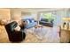 Comfortable living room with sofas, unique coffee table, tile floors, and bright natural light at 3320 Gulf Of Mexico Dr # 307C, Longboat Key, FL 34228
