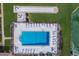 Aerial shot of a fenced in community pool with ample seating and a bocce ball court at 3320 Gulf Of Mexico Dr # 307C, Longboat Key, FL 34228