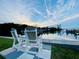 Outdoor view of waterfront, showing dock and outdoor seating, under a clear sky at 3320 Gulf Of Mexico Dr # 307C, Longboat Key, FL 34228