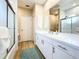 Bathroom featuring a vanity with white cabinets, a large mirror, and a glass-enclosed shower at 3362 Charles Macdonald Dr, Sarasota, FL 34240