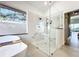 Bathroom featuring a modern tub and shower, with bright, natural light at 3362 Charles Macdonald Dr, Sarasota, FL 34240