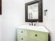Charming bathroom with a decorative mirror and stylish green vanity at 3362 Charles Macdonald Dr, Sarasota, FL 34240