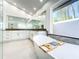 Modern bathroom featuring a soaking tub and double vanity sinks with a large mirror at 3362 Charles Macdonald Dr, Sarasota, FL 34240