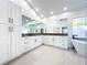 Bright bathroom features double vanity with custom cabinets and a soaking tub at 3362 Charles Macdonald Dr, Sarasota, FL 34240