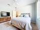 Bedroom featuring a large window, ceiling fan, tv, and an adjoining bathroom at 3362 Charles Macdonald Dr, Sarasota, FL 34240