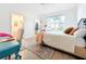 Sunlit bedroom featuring a comfortable bed, a study space, and an open view of the en suite bathroom at 3362 Charles Macdonald Dr, Sarasota, FL 34240