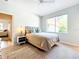 Comfortable bedroom with a large window, ceiling fan, and an adjoining bathroom at 3362 Charles Macdonald Dr, Sarasota, FL 34240