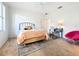 Bright bedroom featuring a cozy bed, stylish desk, and comfortable seating area with natural light at 3362 Charles Macdonald Dr, Sarasota, FL 34240