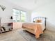 Cozy bedroom featuring natural light, a bookshelf, and a comfortable bed at 3362 Charles Macdonald Dr, Sarasota, FL 34240