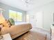 Bright bedroom featuring a large window, neutral decor, and an ensuite bathroom entrance at 3362 Charles Macdonald Dr, Sarasota, FL 34240