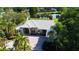 Stunning home with a paver driveway and lush landscaping, with golf course and pond views in the background at 3362 Charles Macdonald Dr, Sarasota, FL 34240