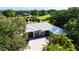 Stunning home with a paver driveway and lush landscaping, with golf course and pond views in the background at 3362 Charles Macdonald Dr, Sarasota, FL 34240
