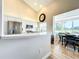 Kitchen with stainless steel appliances, white cabinets, and a curved counter overlooking the breakfast nook at 3362 Charles Macdonald Dr, Sarasota, FL 34240