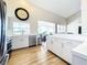 Bright kitchen features white cabinetry, stainless steel appliances, and wood-look flooring at 3362 Charles Macdonald Dr, Sarasota, FL 34240