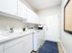 Well-equipped laundry room with sink, washer, dryer and ample cabinet space at 3362 Charles Macdonald Dr, Sarasota, FL 34240