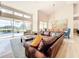 Bright and airy living room with a large window and sliding glass doors, neutral walls, stylish furnishings, and wood floors at 3362 Charles Macdonald Dr, Sarasota, FL 34240