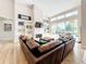 Open living room with high ceilings, fireplace, built-in shelving and views to the outdoor living space at 3362 Charles Macdonald Dr, Sarasota, FL 34240