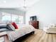 Bright main bedroom features wood floors, high ceilings, and sliding glass doors to the lanai at 3362 Charles Macdonald Dr, Sarasota, FL 34240