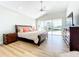 Tranquil main bedroom with a ceiling fan and sliding doors leading to the screened patio at 3362 Charles Macdonald Dr, Sarasota, FL 34240