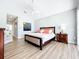 The main bedroom has wood floors, a ceiling fan, and a comfortable bed at 3362 Charles Macdonald Dr, Sarasota, FL 34240