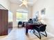 Home office with a large window offering natural light and views of the surrounding landscape at 3362 Charles Macdonald Dr, Sarasota, FL 34240