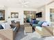 Covered outdoor seating area with ceiling fan, TV, and comfortable furniture at 3362 Charles Macdonald Dr, Sarasota, FL 34240