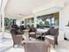 Outdoor patio features wicker furniture, ceiling fan, and sliding glass doors at 3362 Charles Macdonald Dr, Sarasota, FL 34240