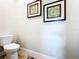 Quaint powder room with decorative art and fixtures at 3362 Charles Macdonald Dr, Sarasota, FL 34240