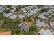 Aerial view of a residential community surrounded by lush greenery and featuring an enclosed swimming pool at 3666 Bonaventure Ct, Sarasota, FL 34243