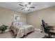 Comfortable bedroom with a ceiling fan, desk, and a large bed featuring a cozy comforter at 3666 Bonaventure Ct, Sarasota, FL 34243