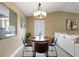 Cozy dining area featuring a round table, seating for four, a bright window, and open access to living room at 3666 Bonaventure Ct, Sarasota, FL 34243