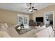 Open-concept living room featuring lots of seating, tv, and access to the lanai and bedroom at 3666 Bonaventure Ct, Sarasota, FL 34243