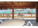Picturesque beach view from a shaded deck with inviting lounge furniture at 3740 Lake Bayshore Dr # 501, Bradenton, FL 34205