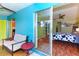 Cozy bedroom featuring unique accent wall and sliding glass doors to a small patio at 3740 Lake Bayshore Dr # 501, Bradenton, FL 34205