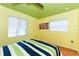Sunny bedroom featuring two windows and hardwood flooring at 3740 Lake Bayshore Dr # 501, Bradenton, FL 34205