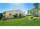 Exterior view of a community building with manicured lawns and lush tropical landscaping at 3740 Lake Bayshore Dr # 501, Bradenton, FL 34205