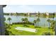 Scenic view of a well-maintained community featuring a large pond, shuffleboard, and manicured landscaping at 3740 Lake Bayshore Dr # 501, Bradenton, FL 34205