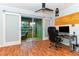 A home office with glass sliding doors leading to a sunroom at 3740 Lake Bayshore Dr # 501, Bradenton, FL 34205