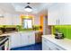 Modern kitchen featuring white countertops and backsplash with green accent at 3740 Lake Bayshore Dr # 501, Bradenton, FL 34205