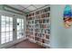Library with well-stocked bookshelves and natural light at 3740 Lake Bayshore Dr # 501, Bradenton, FL 34205