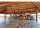 Spacious outdoor bar with colorful seating and a thatched roof, creating a tropical ambiance at 3740 Lake Bayshore Dr # 501, Bradenton, FL 34205