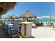 Relaxed beachfront restaurant featuring colorful chairs and umbrellas for a tropical ambiance at 3740 Lake Bayshore Dr # 501, Bradenton, FL 34205