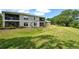 Backyard view of building, showing a walkout area, green grass, and nice scenery at 383 Bobby Jones Rd # 383, Sarasota, FL 34232