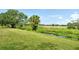 The backyard features a pond, grassy area, and golf course in the distance at 383 Bobby Jones Rd # 383, Sarasota, FL 34232