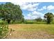 The backyard is a green oasis with a golf course view and lush, mature trees at 383 Bobby Jones Rd # 383, Sarasota, FL 34232