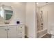 Bright bathroom features a modern vanity with a round mirror and a shower-tub combo at 383 Bobby Jones Rd # 383, Sarasota, FL 34232