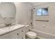 Bathroom features modern vanity, round mirror, and tiled shower-tub combo with handrails at 383 Bobby Jones Rd # 383, Sarasota, FL 34232