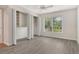 Bright bedroom with gray wood-look flooring, ceiling fan, and closet with folding doors at 383 Bobby Jones Rd # 383, Sarasota, FL 34232